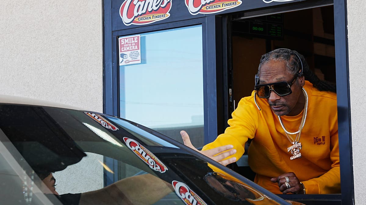 snoop dogg serving a customer at raising cane's 