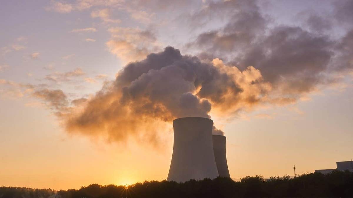 Steam rises from cooling towers at a nuclear facility.