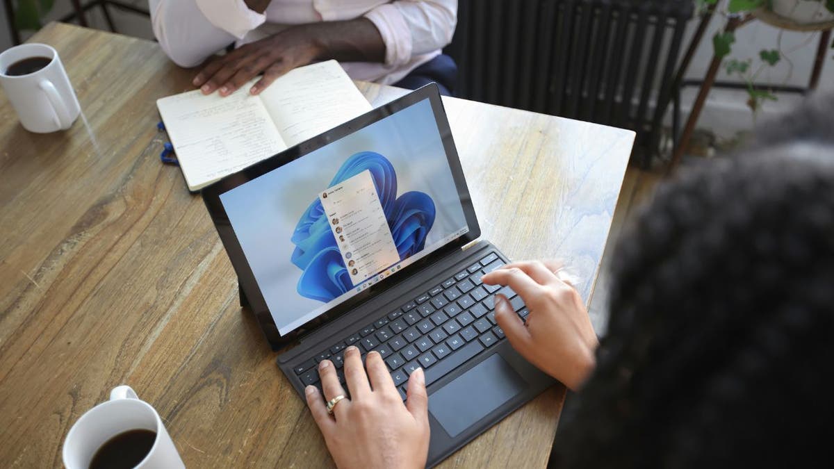 A woman using Microsoft 365 on her laptop.