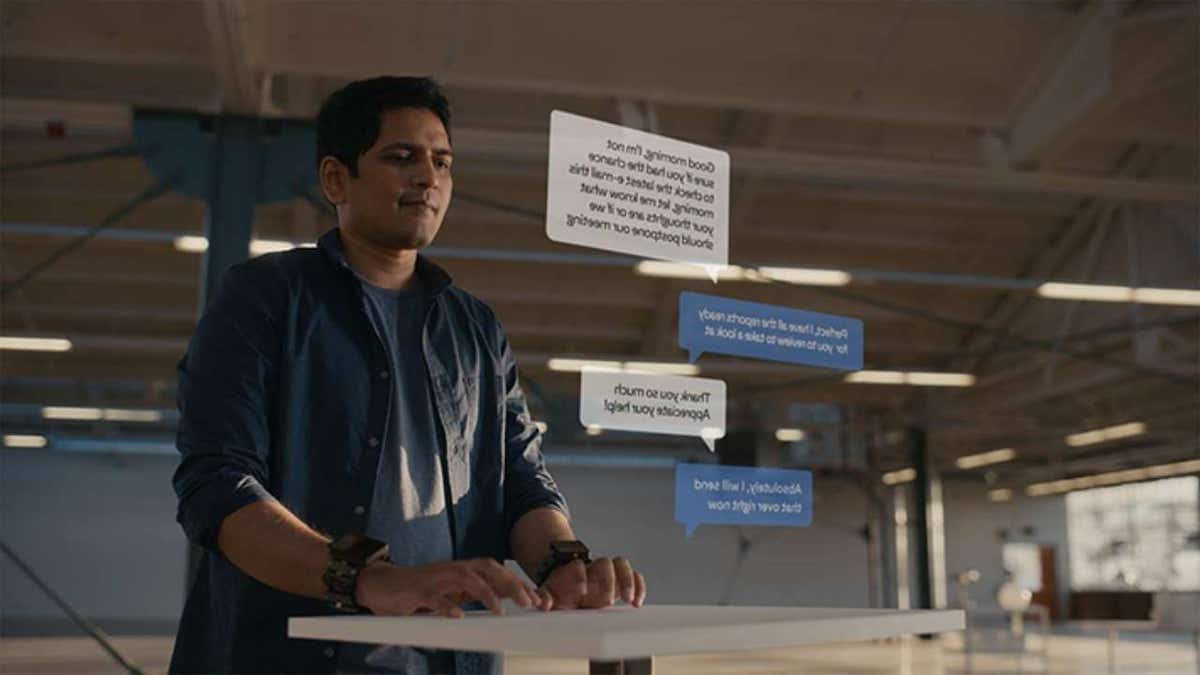 A man wearing a Meta wristband that converts his hand gestures into commands.