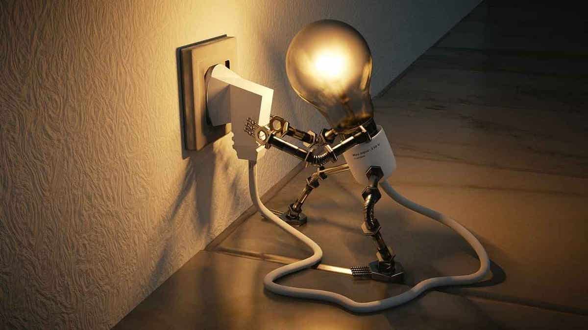 A light bulb with arms and legs connects itself to the wall outlet.