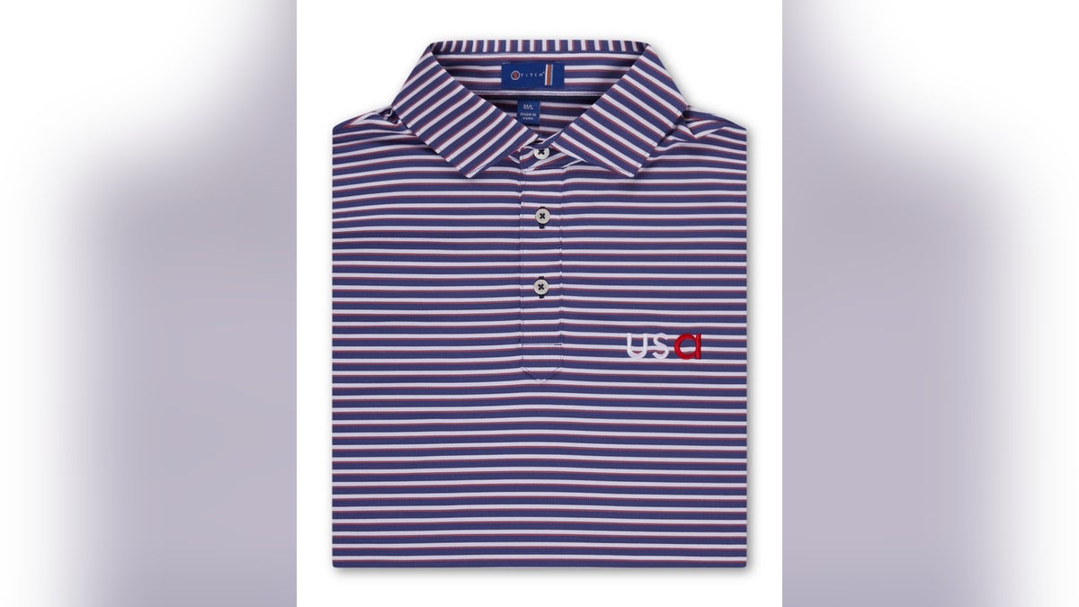 This polo combines luxe fabrics with tour-level style, emblazoned with patriotic elements.