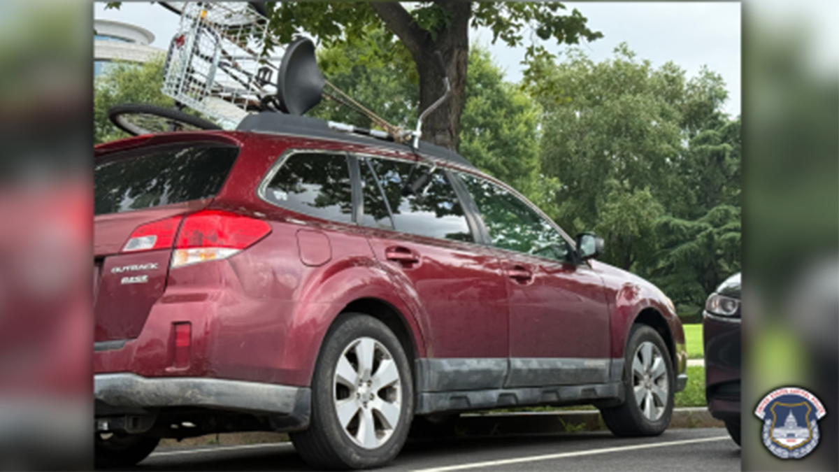 A large tricycle was being carried by the suspicious car.