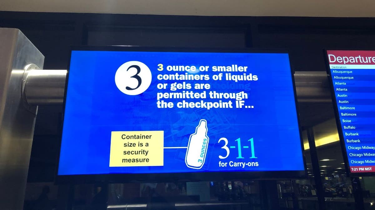 3.4 ounce liquid sign in an airport