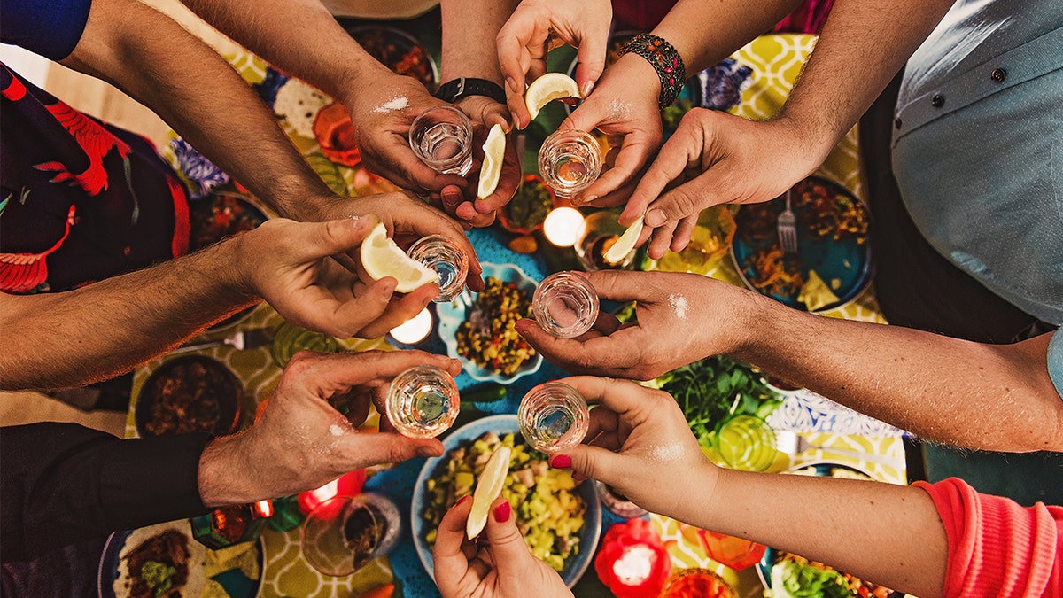 Party of friends drinking tequila