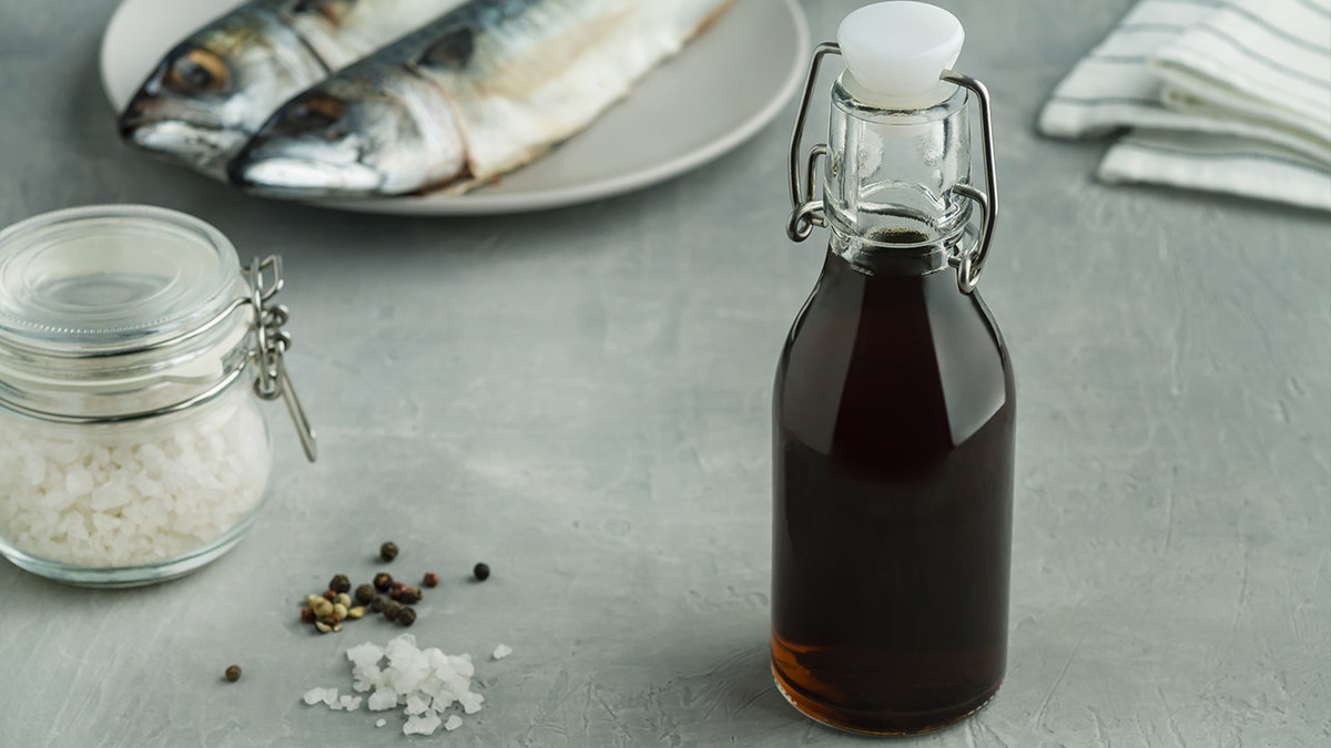 View of Garum next to salt, pepper and sardines