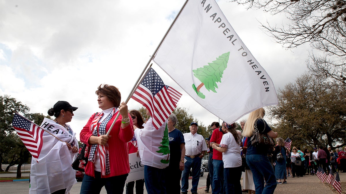 Woman holding Appeal to Heaven flag