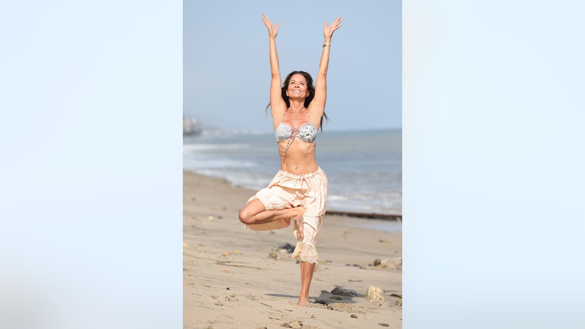Brooke Burke doing tree pose