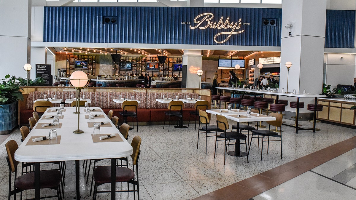 Bubby's restaurant at LGA Airport seen from outside, tables set up with no customers