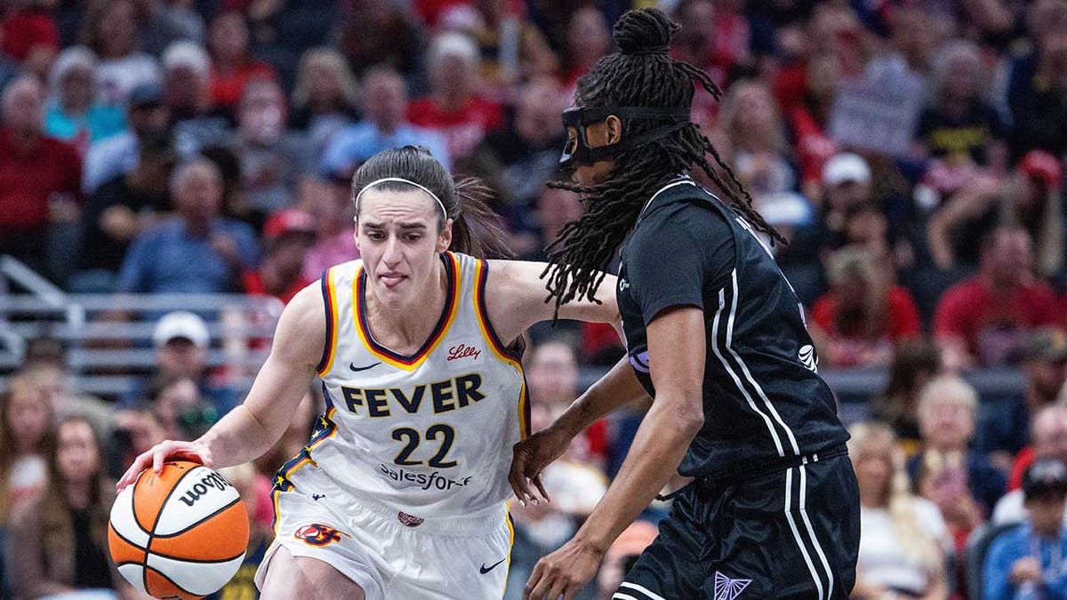 Caitlin Clark dribbles