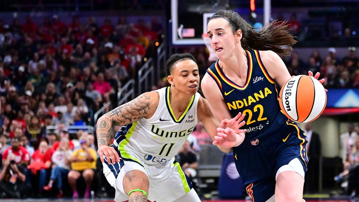 Caitlin Clark drives past JJ Quinerly