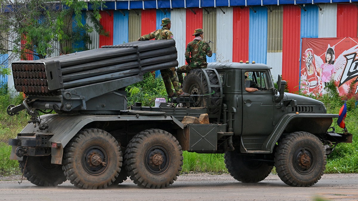 Soldiers in Cambodia ride on a truck