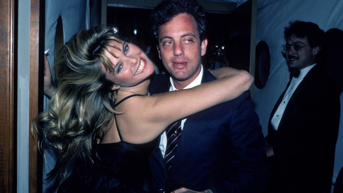 Christie Brinkley embracing Billy Joel in 1983