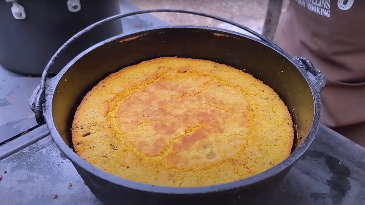 Kent Rollins shows off the cornbread he made in this cast-iron dutch oven.