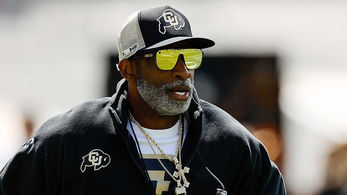 Deion Sanders looks on