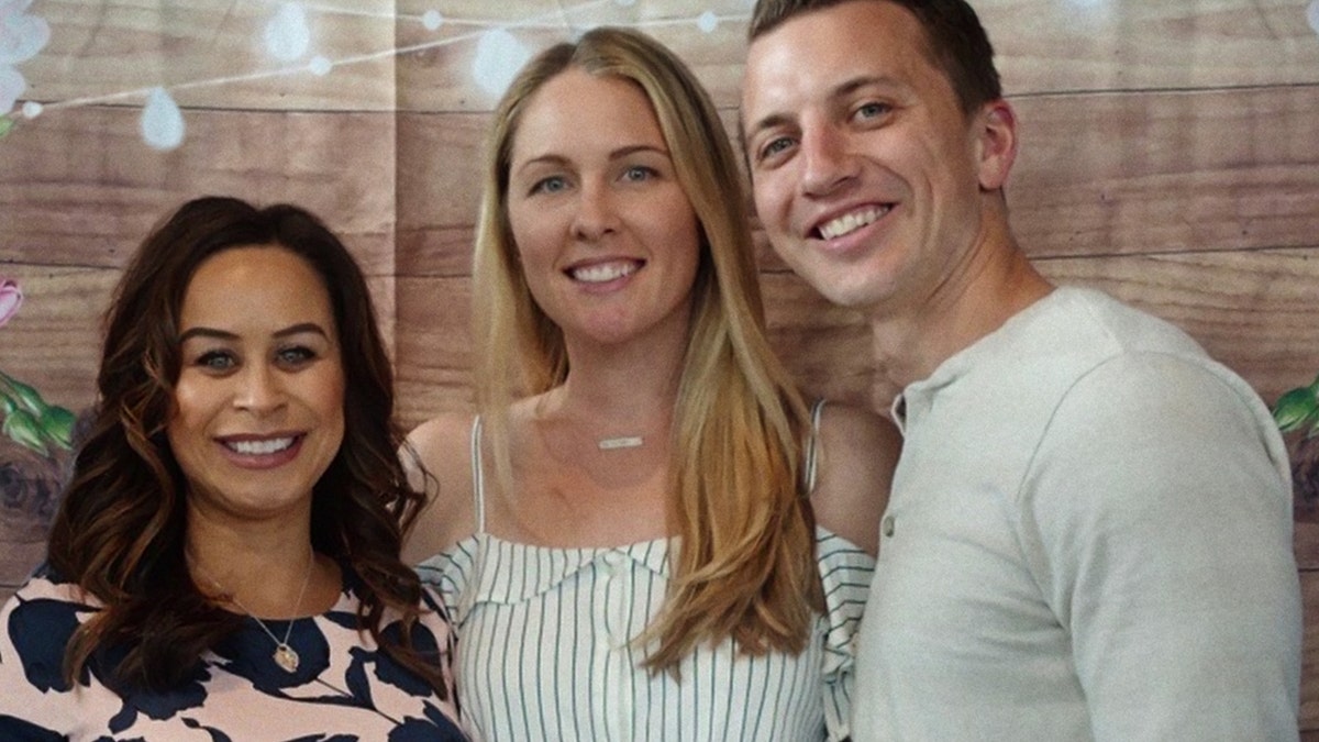 Misty Carausu, Denise Huskins and Aaron Quinn smile for a group photo.