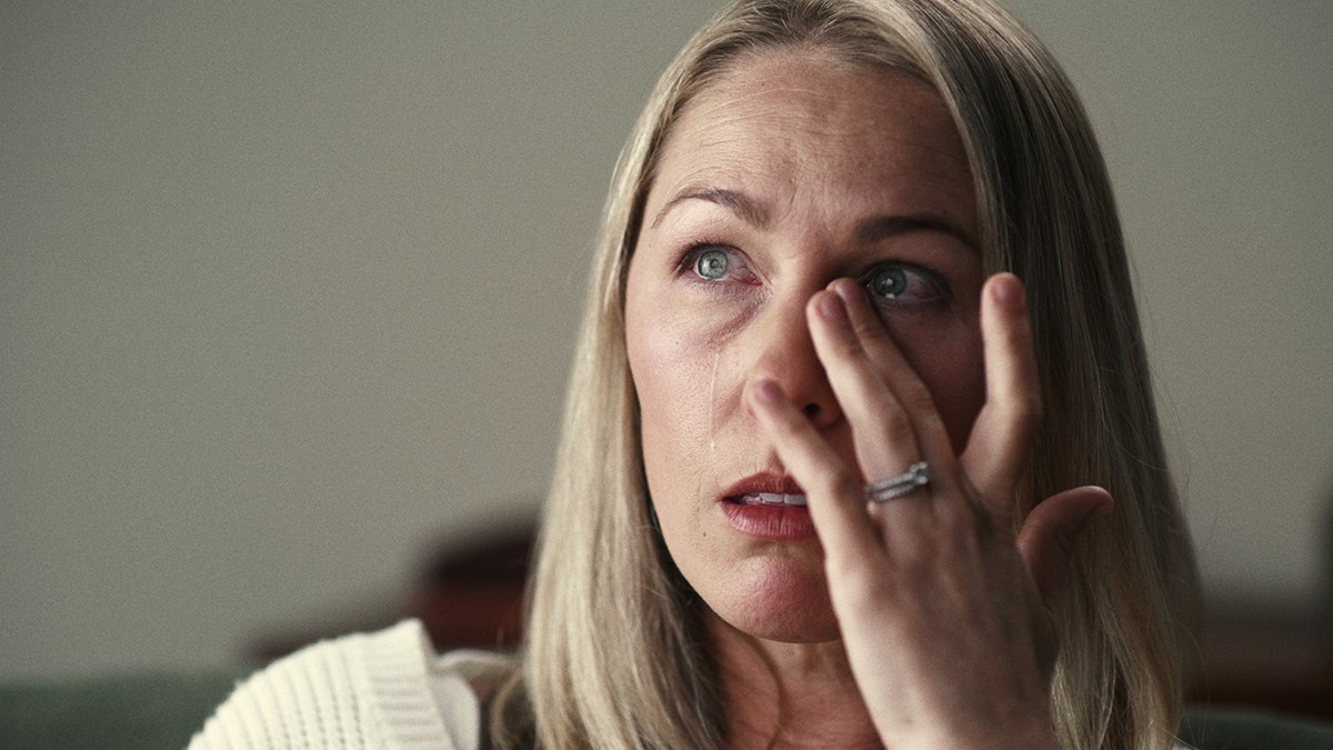 A close-up of Denise Huskins crying and rubbing her eye.