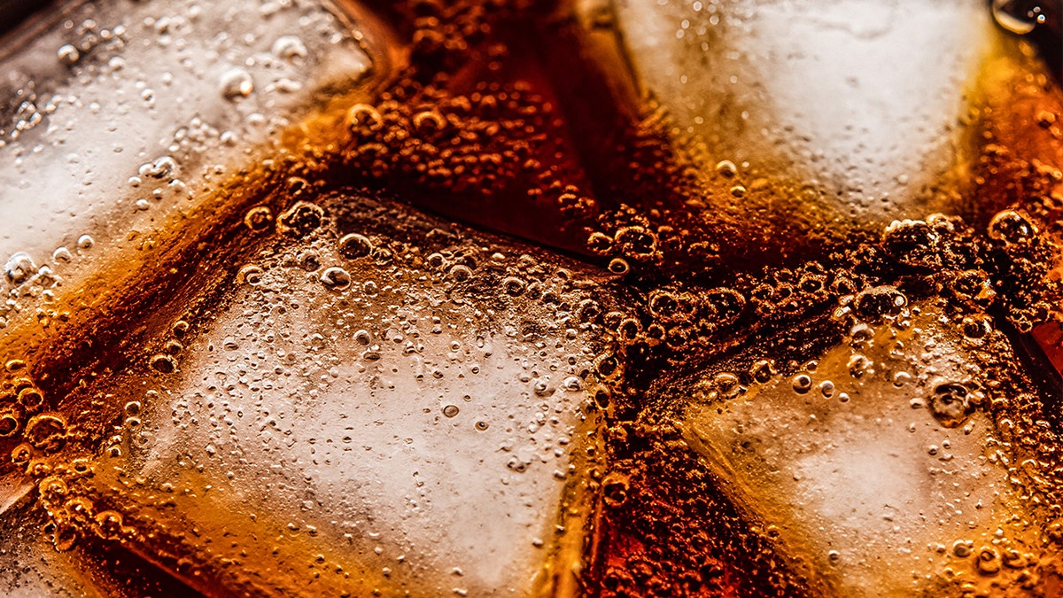 Close-up of ice in soda, carbonation bubbles
