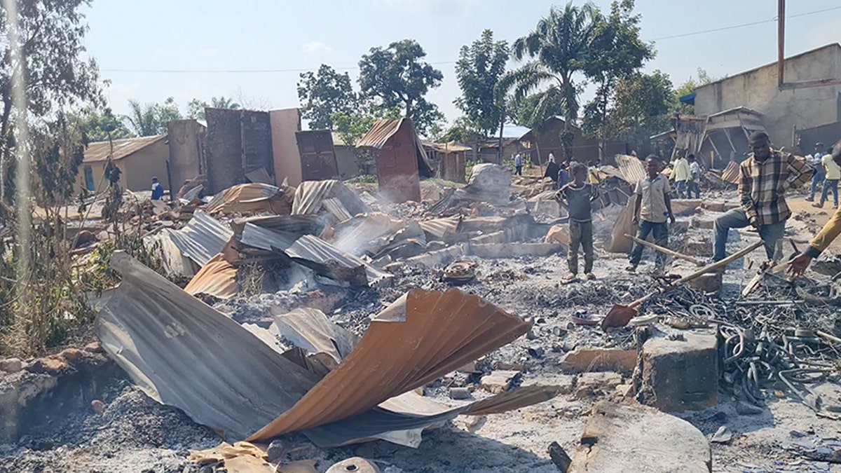 A screenshot shows villagers inspecting the damage left by jihadi terrorists who killed 49 Christians in DR Congo on Sunday.