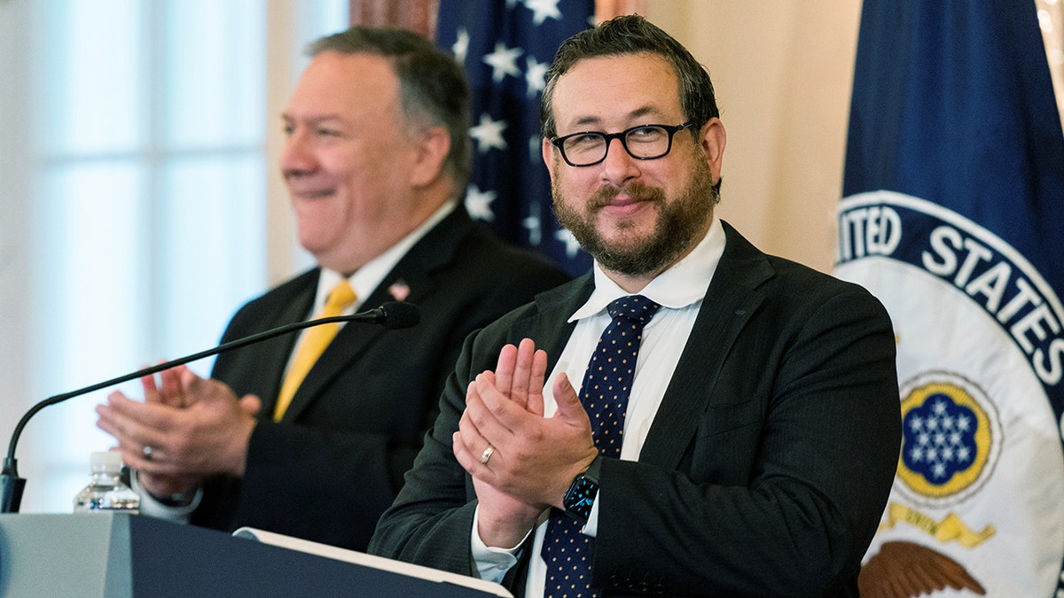 U.S. Citizenship and Immigration Services Deputy Director for Policy Joseph Edlow and Secretary of State Mike Pompeo, applaud and congratulate the new Americans during a naturalization ceremony at the State Department in Washington, U.S. October 22, 2020