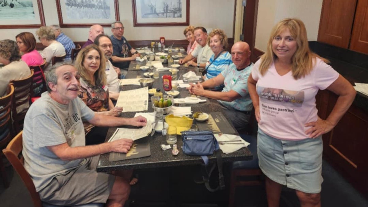 Ellen Fried poses for a photograph with a group attending her "meat up."
