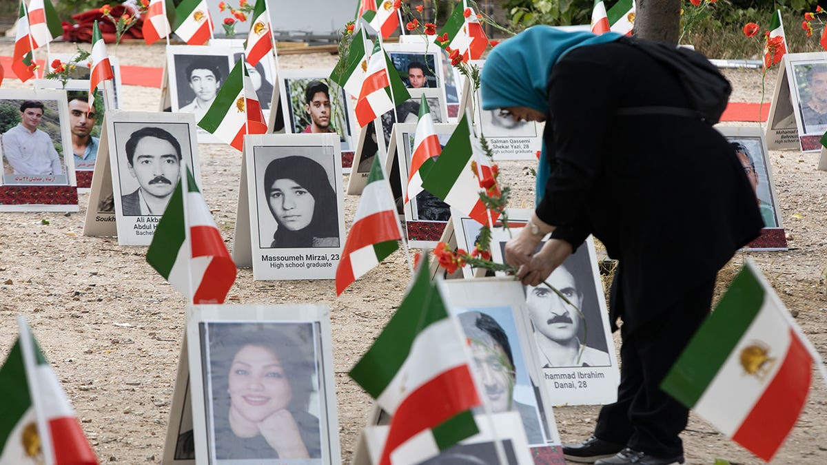 Woman mourns at site honoring those executed by Iran.