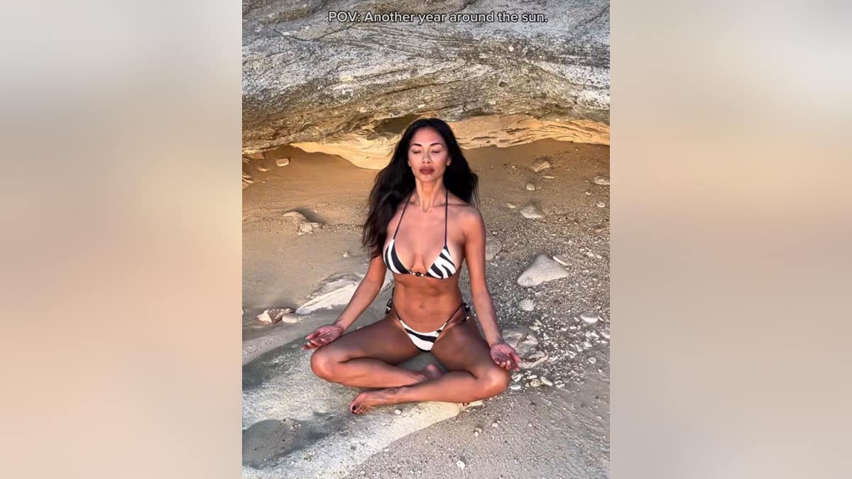 nicole scherzinger strikes a yoga pose on the beach
