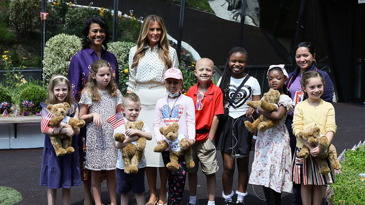 US First Lady Melania Trump accompanied by Children's National Hospital President and CEO Michelle Riley-Brown (top-L) poses for a picture with patients during a visit at Children's National Hospital in Washington, DC on July 3, 2025. (Photo by Jemal COUNTESS / AFP) (Photo by JEMAL COUNTESS/AFP via Getty Images)