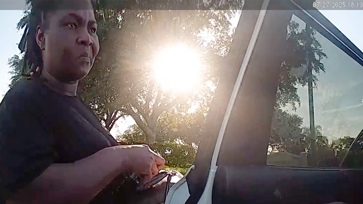 Marianne Isnar talks to a police officer.
