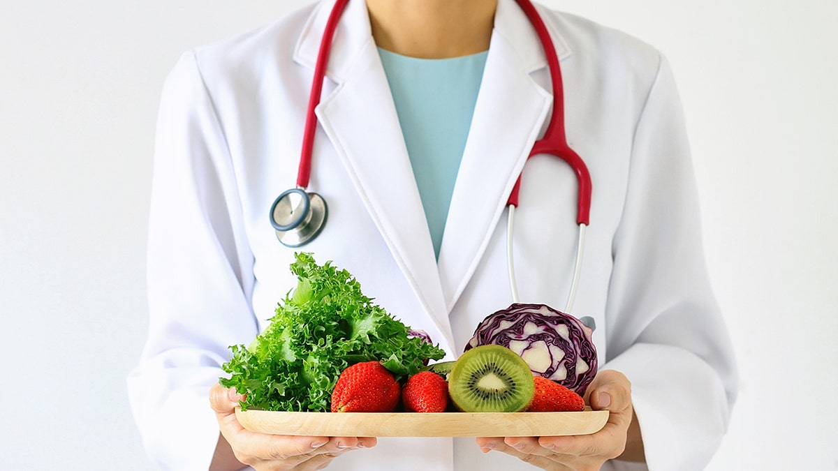 Photo of expert holding sheet of fruits and vegetables