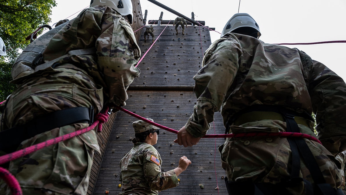 Cadets scale a training wall at Fort Knox