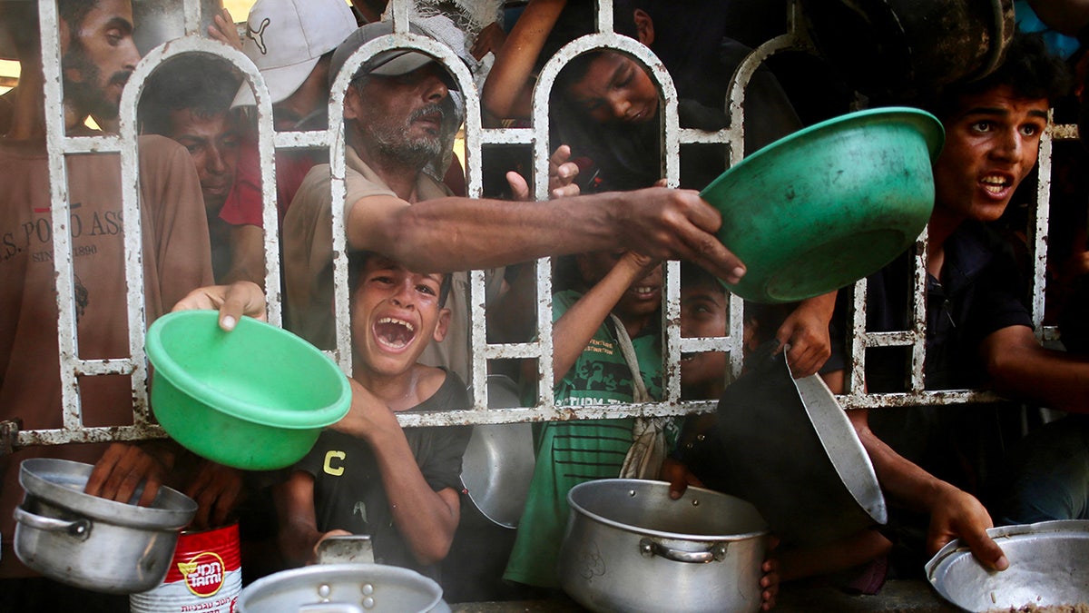 The Palestinians line up to receive a meal in Gaza