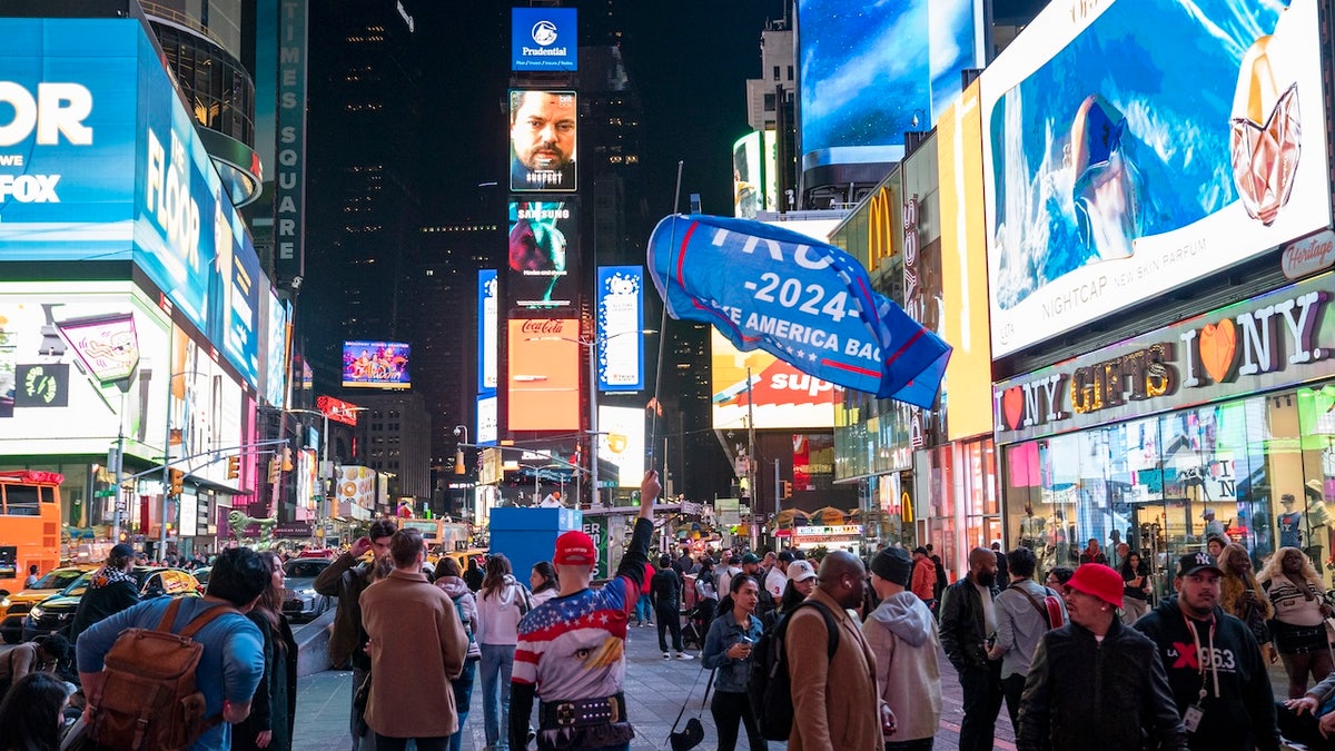 A pro-Trump protagonist holds a banner successful Times Square connected November 5, 2024 successful New York City. Americans formed their ballots coming successful nan statesmanlike title betwixt Republican nominee erstwhile President Donald Trump and Democratic nominee Vice President Kamala Harris, arsenic good arsenic aggregate authorities elections that will find nan equilibrium of powerfulness successful Congress. (Photo by Robert Nickelsberg/Getty Images)