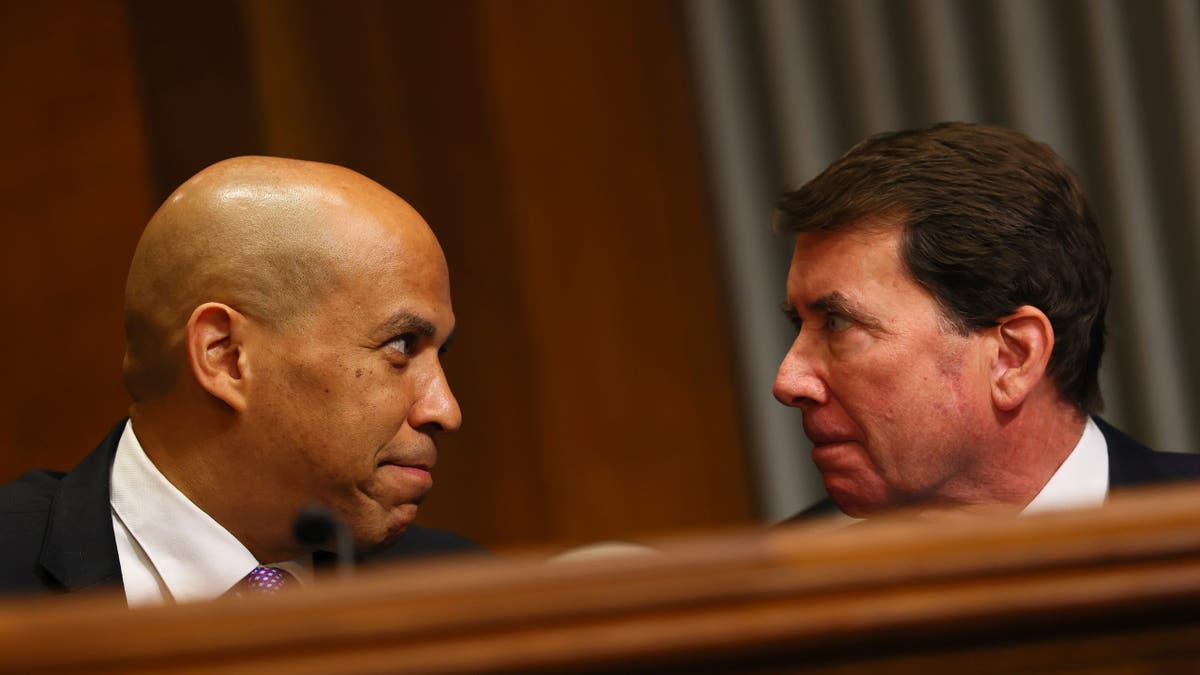 Sen. Cory Booker (D-N.J.) and Sen. Bill Hagerty (R-Tenn.) speak during a confirmation hearing before the Senate Committee on Foreign Relations in the Dirksen Senate Office Building on July 15, 2025, in Washington.