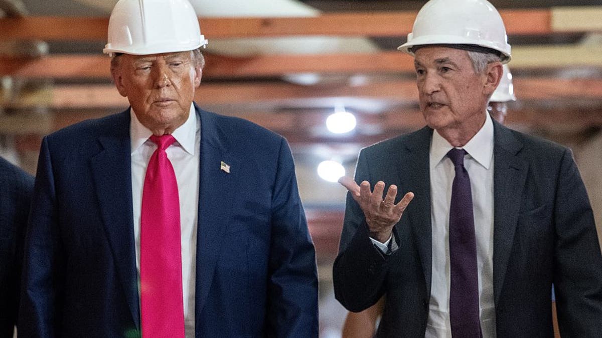 President Donald Trump speaks with Federal Reserve chair Jerome Powell (right) as he visits the Federal Reserve in Washington, July 24, 2025. 