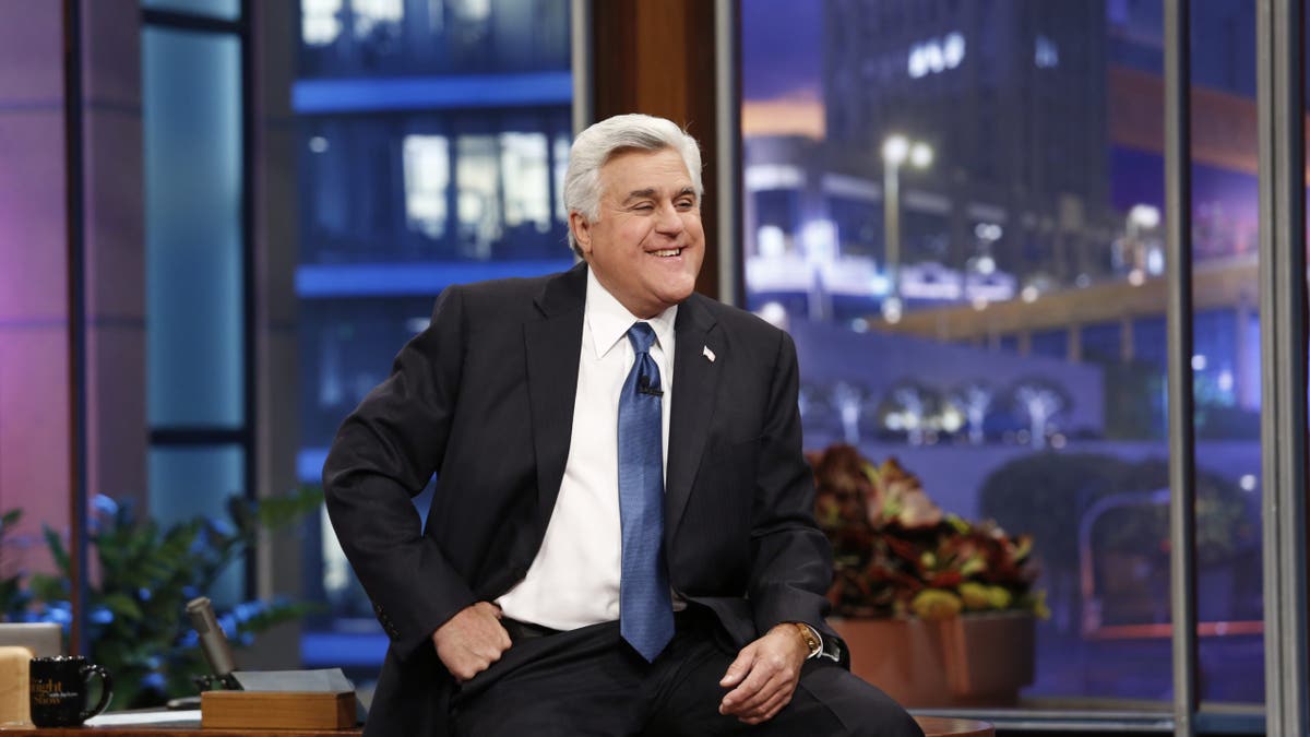 jay leno sitting on his desk on the tonight show