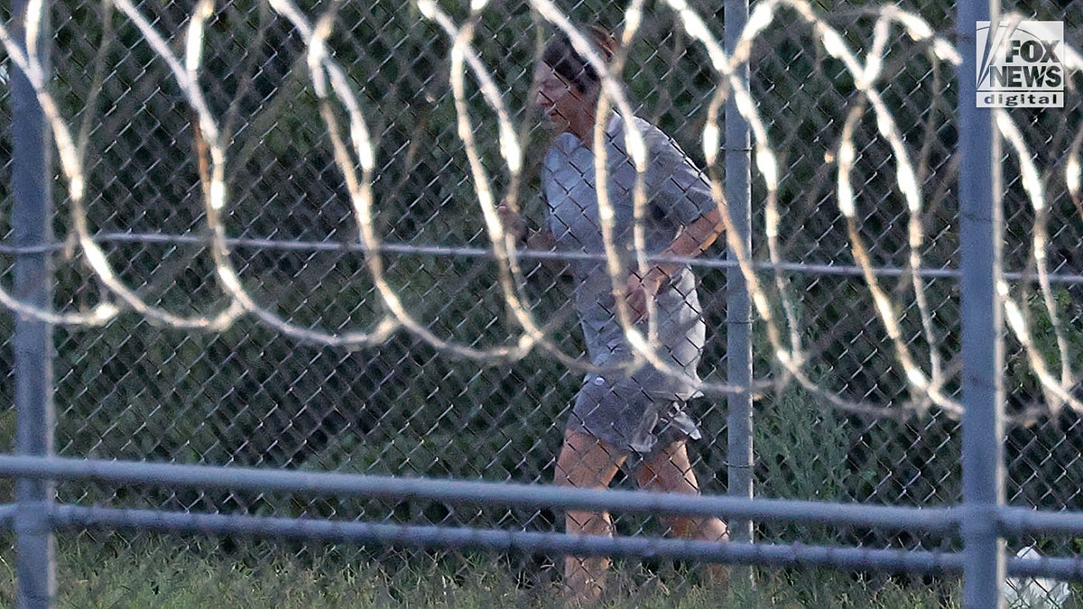 Ghislaine Maxwell is seen behind razor wire in prison