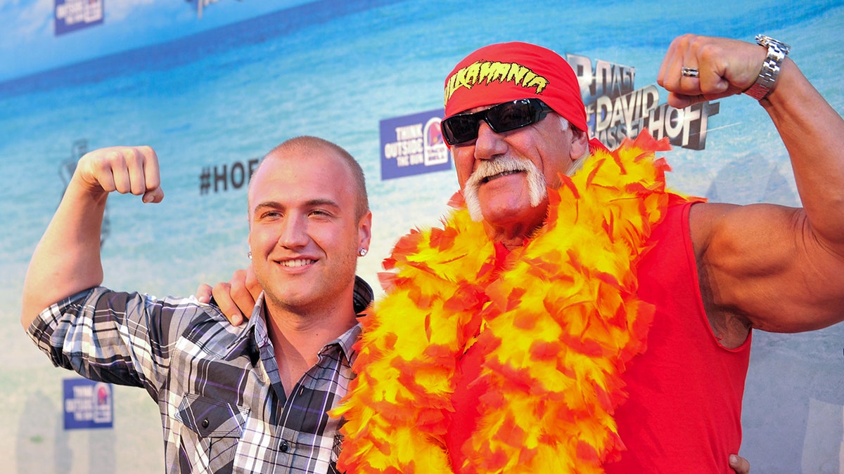 Nick and Hulk Hogan poses on red carpet