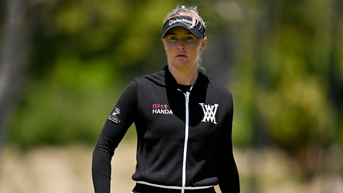 Charley Hull looks on
