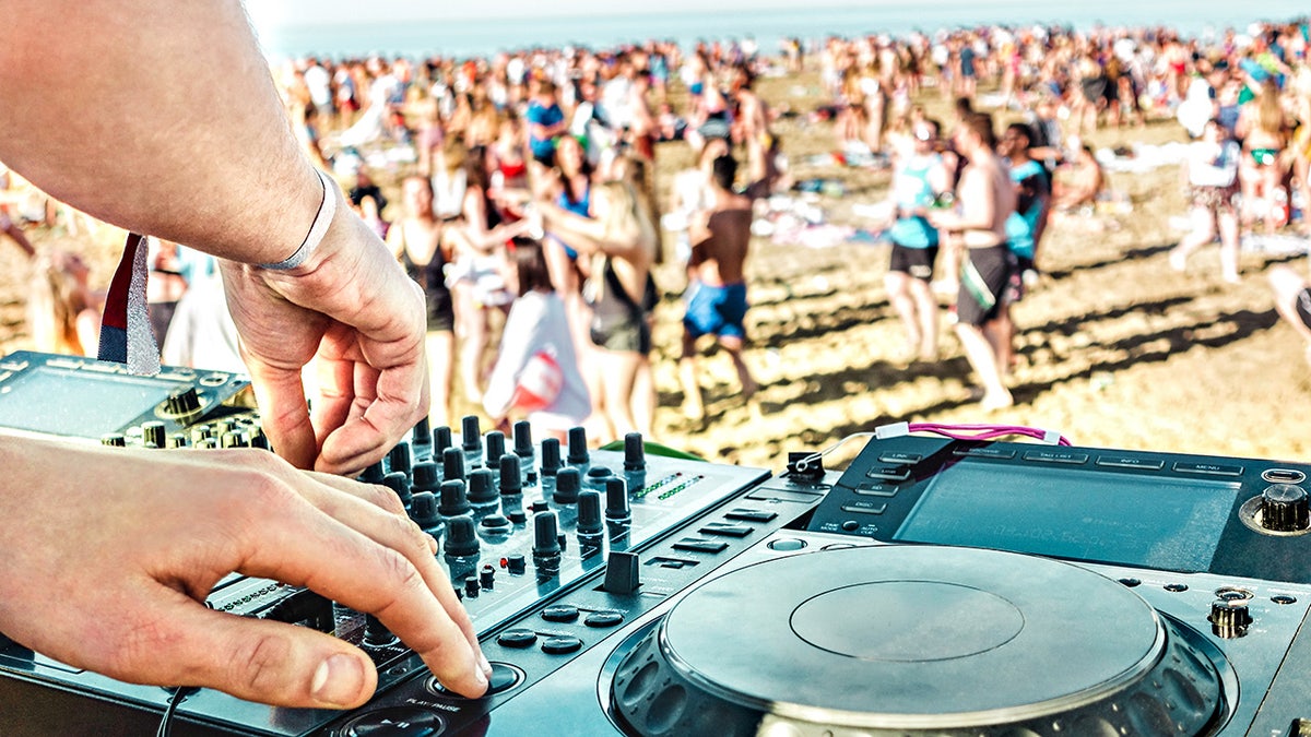 Detail of dj playing modern sound on cd usb player at spring break festival in Ibiza
