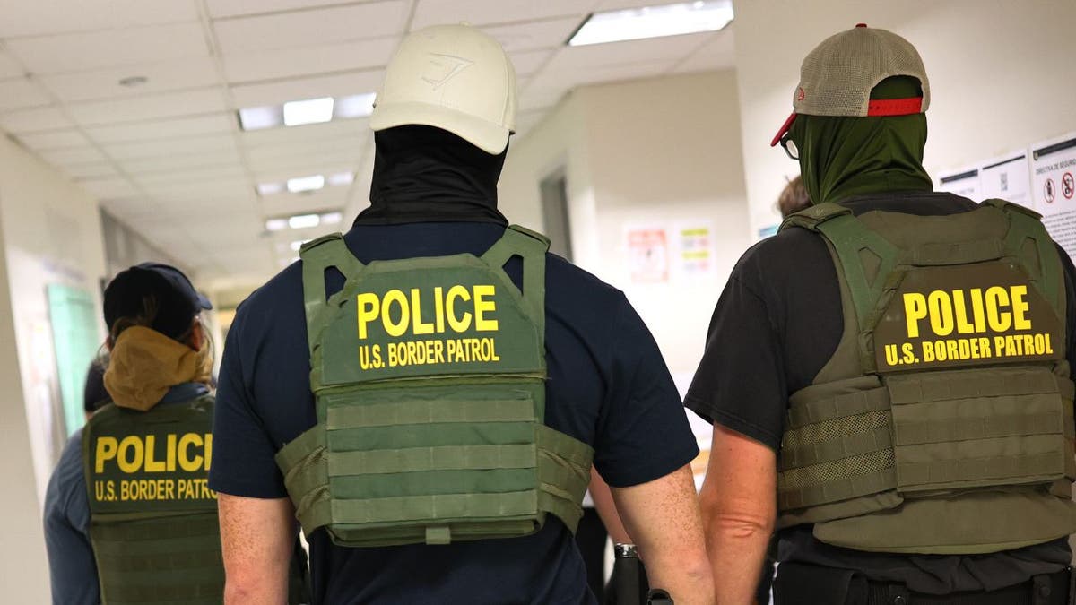 ICE agents walking