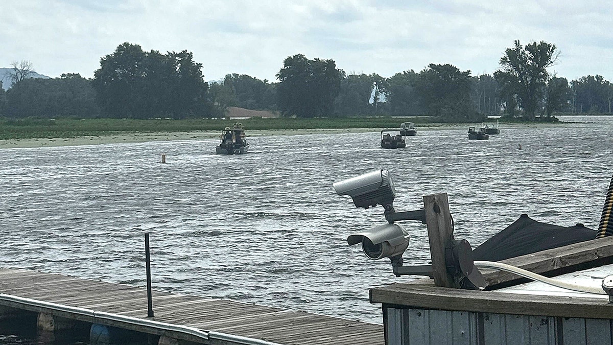 A photo taken by the marina bar owner's daughter shows authorities discovering Eliotte Heinz's body in the Mississippi River on Wednesday, July 23, 2025.