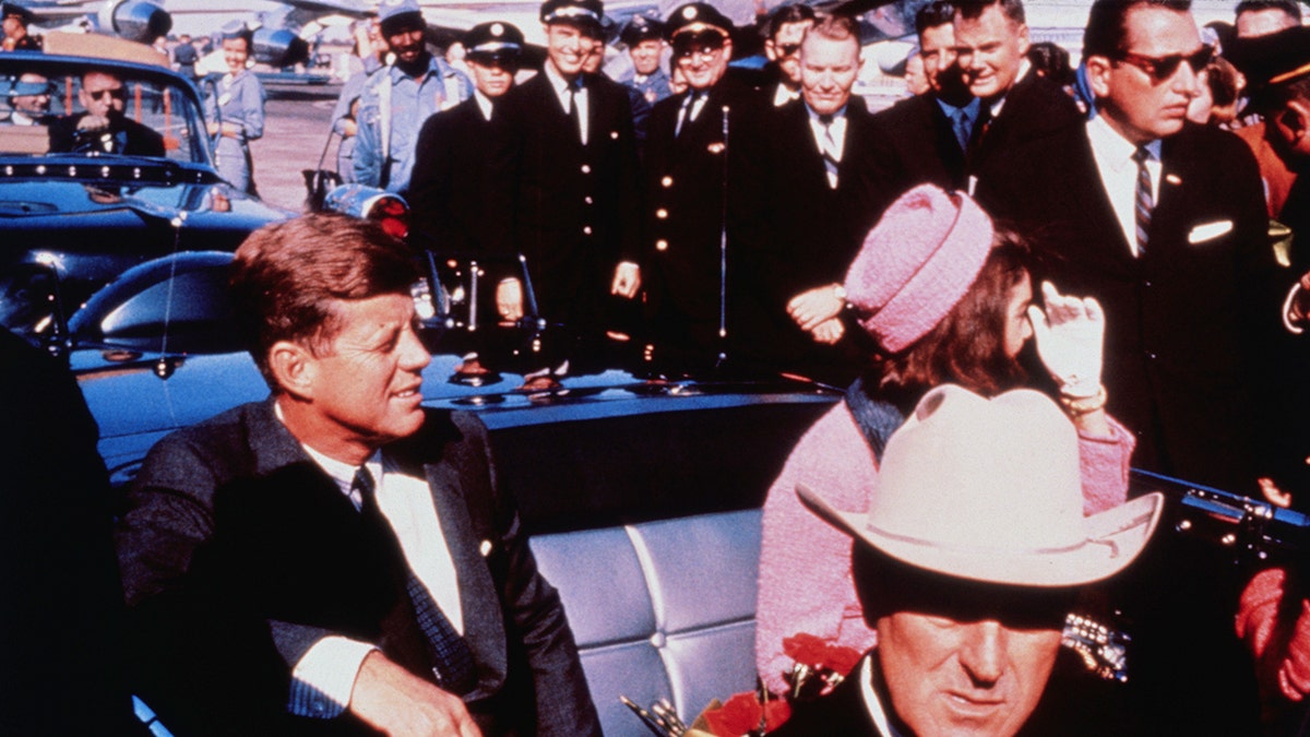 JFK and Jackie Kennedy settled in rear seats driving into Texas.