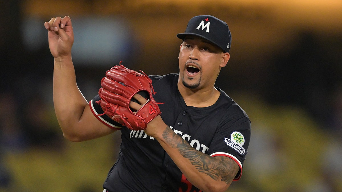 Jhoan Duran reacts after pitch