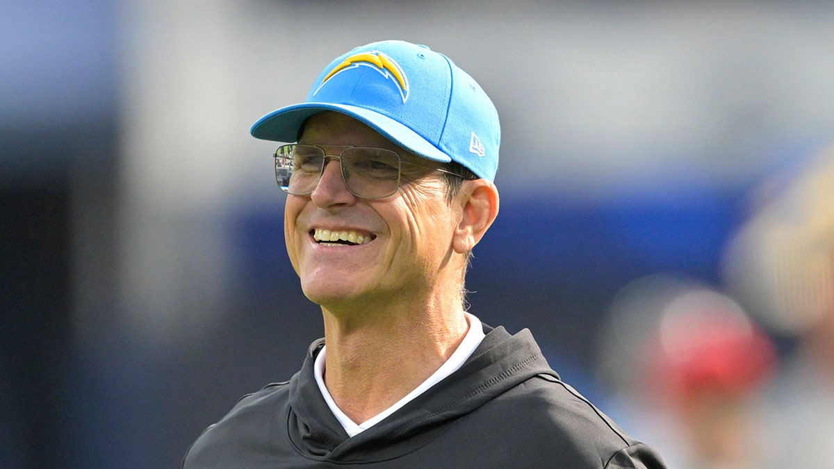 Jim Harbaugh smiling before a game