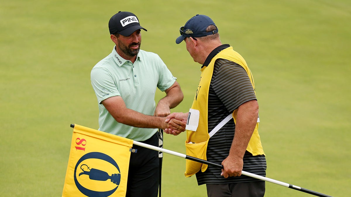 John Parry shakes hands pinch caddy