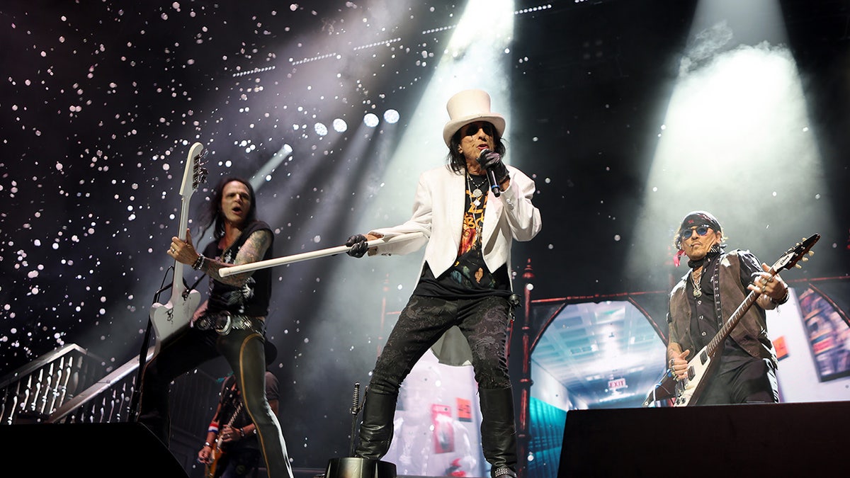 Alice Cooper and Johnny Depp performing together.