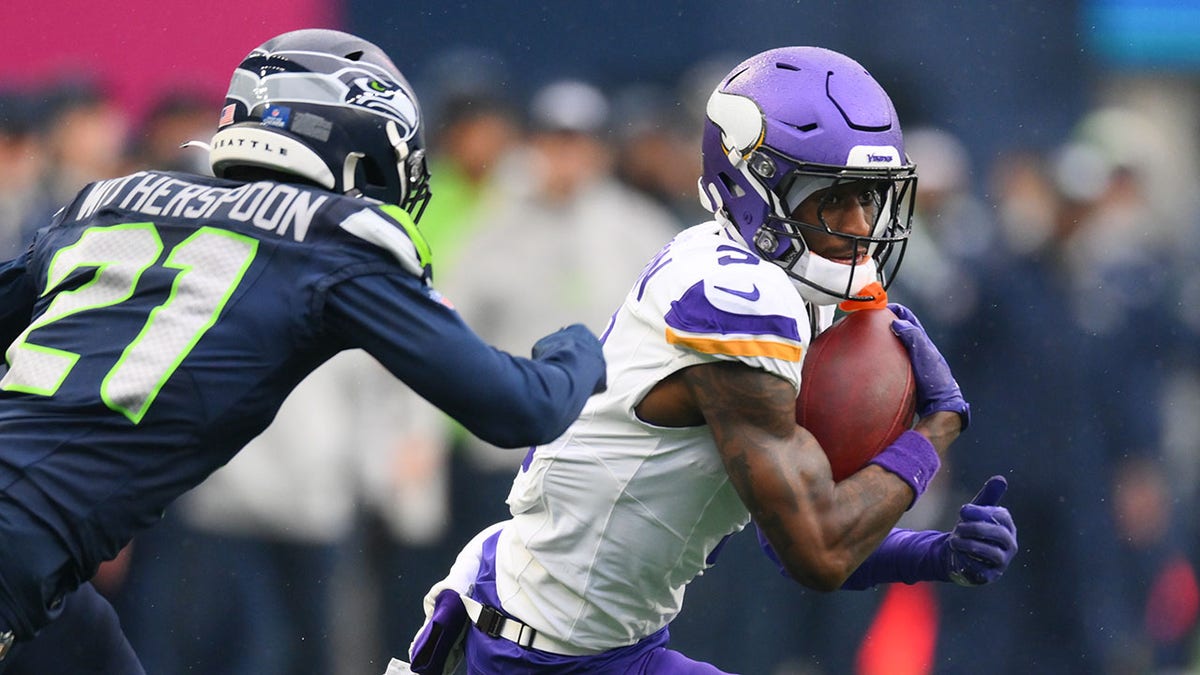 Jordan Addison carries the ball
