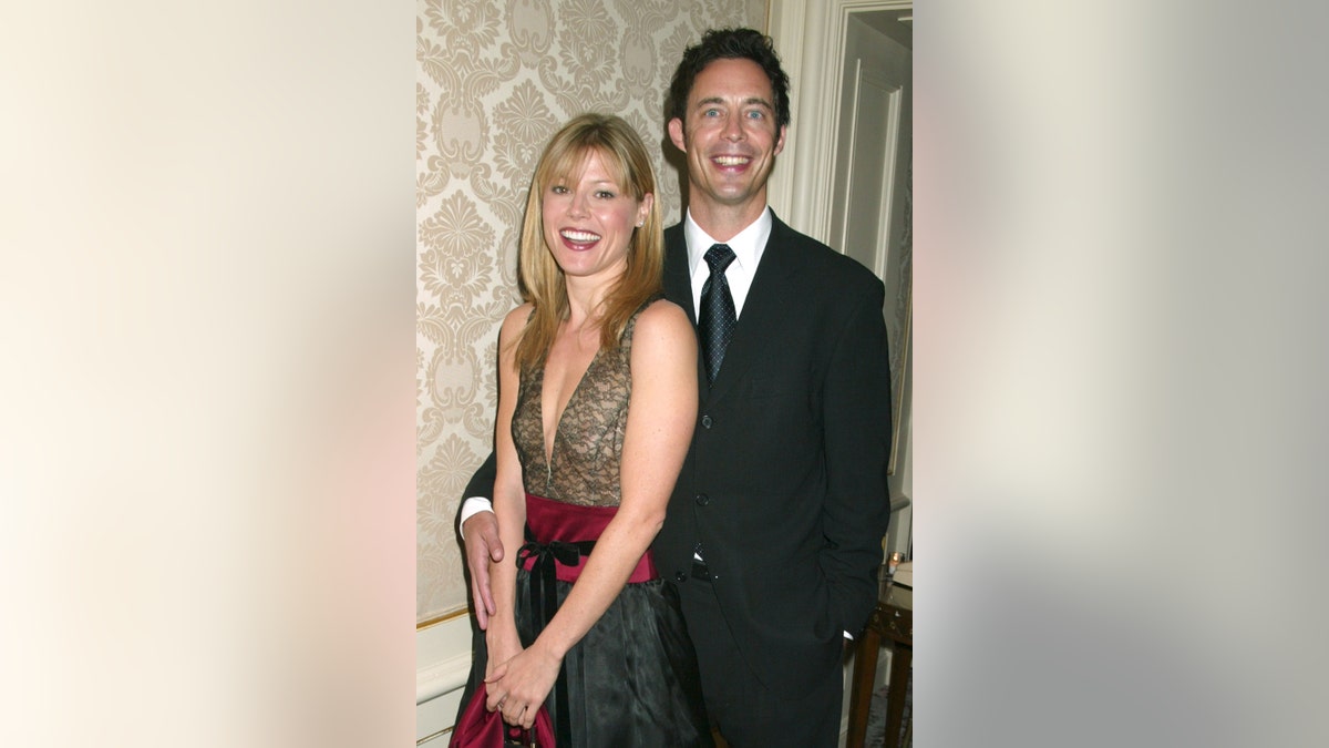 Julie Bowen smiling with her "Ed" co-star in a suit and black tie.