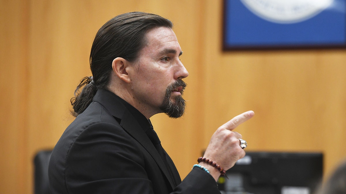 Attorney Kevin Smith wearing achromatic suit pointing digit successful courtroom